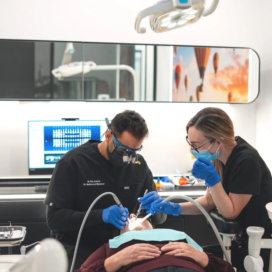 A dentist and a dental assistant performing a dental procedure.